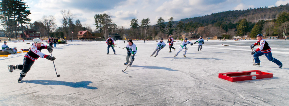 Pond Hockey Players fighting for the puck